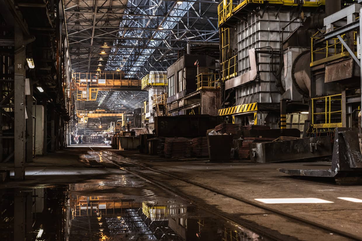 Interior of a large industrial production facility with heavy plant and machinery