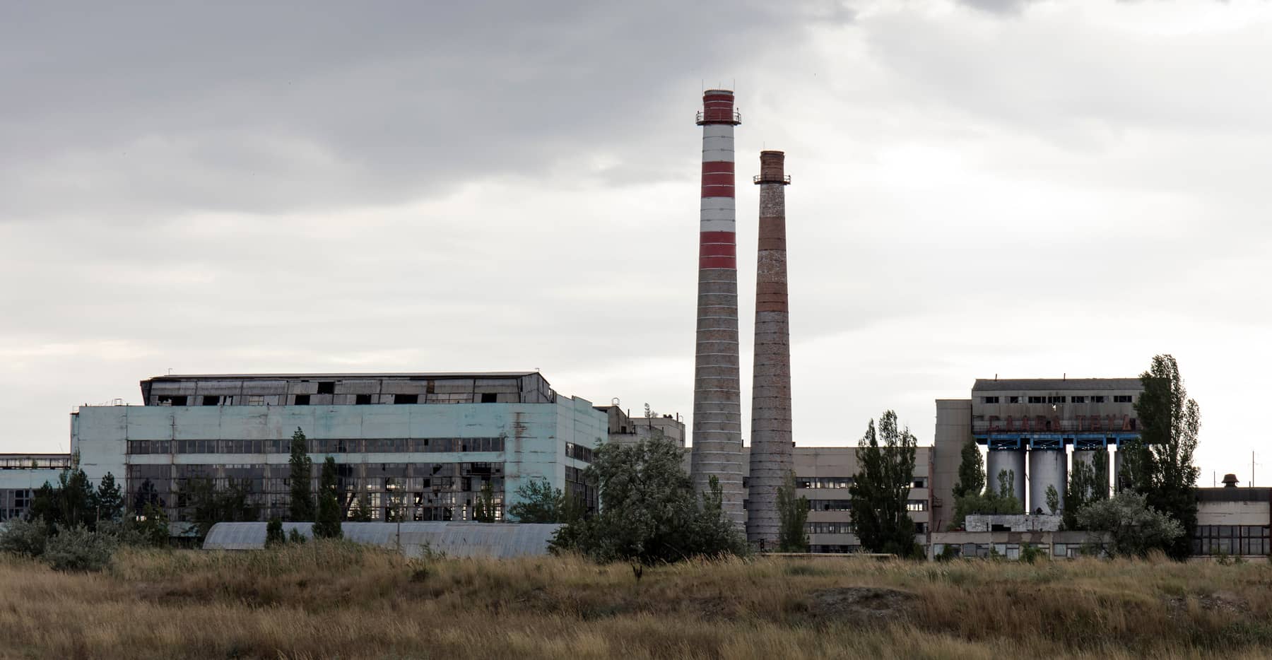 Large industrial site with factory buildings and tall chimneys